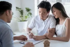 Couple signing up for home insurance