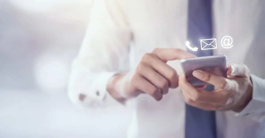 A business man scrolling through his contact list